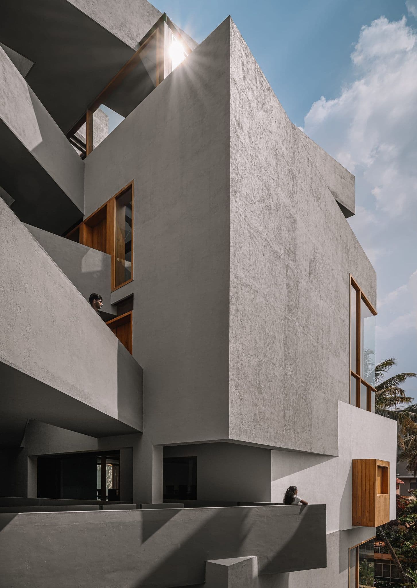Hira — layered concrete volumes and human scale against the Bangalore sky