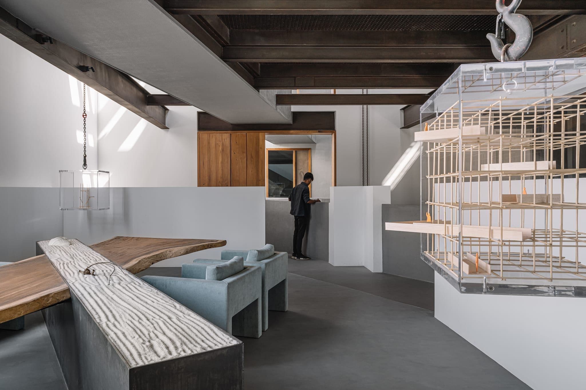 Fulcrum Studio workspace with a long sculptural table under an exposed ceiling.